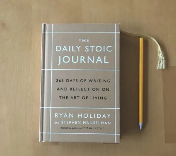 Front cover of a Stoic journal beside a pencil